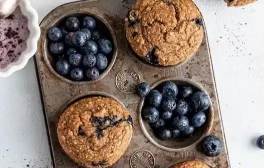 Freshly baked blueberry oat muffins on a wooden table