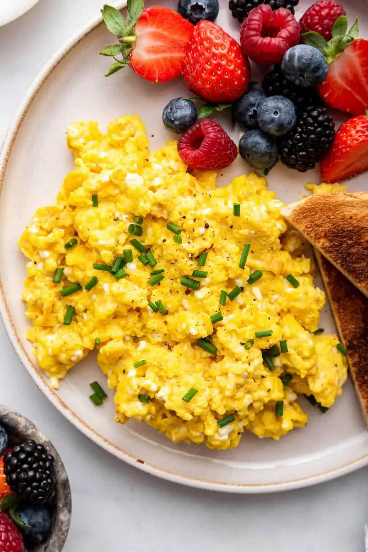 Scrambled cottage cheese eggs plated with herbs and spices
