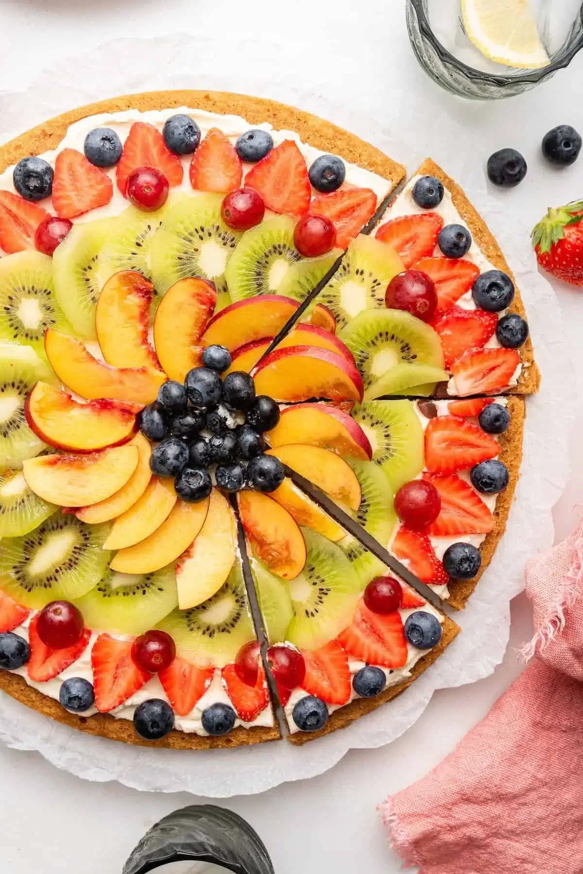 Colorful fruit pizza topped with an assortment of fresh fruits on a sweet crust