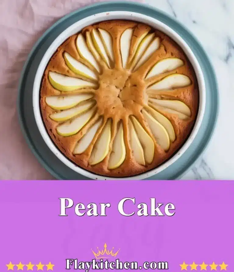 Delicious pear cake topped with fresh pear slices and a dusting of powdered sugar.
