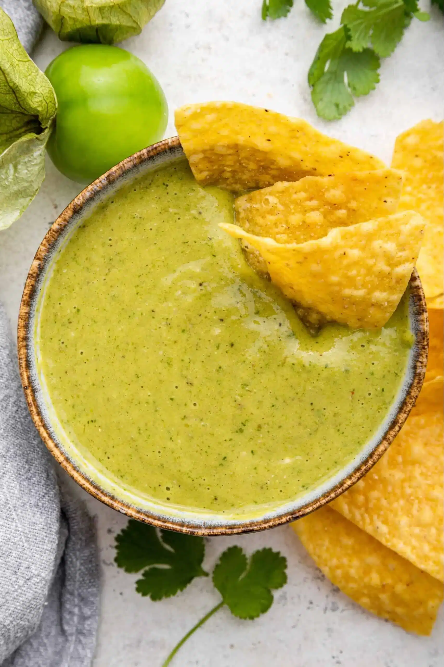 Delicious homemade Roasted Tomatillo Salsa served in a bowl with fresh ingredients