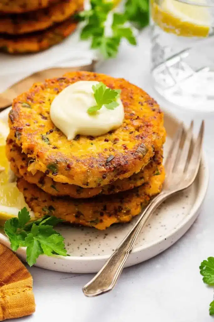 Homemade salmon patties cooked to golden perfection on a plate.