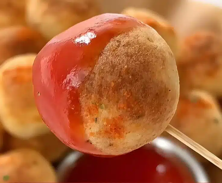 Golden crispy potato balls made without frying, showcasing a delicious snack.