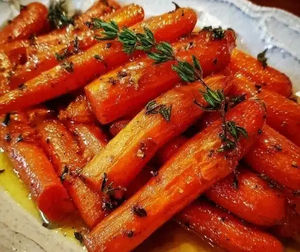 Delicious honey roasted carrots with thyme served on a plate