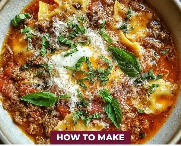 Crock Pot Lasagna Soup 9 Delicious Crock Pot Lasagna Soup in a bowl with melted cheese and herbs