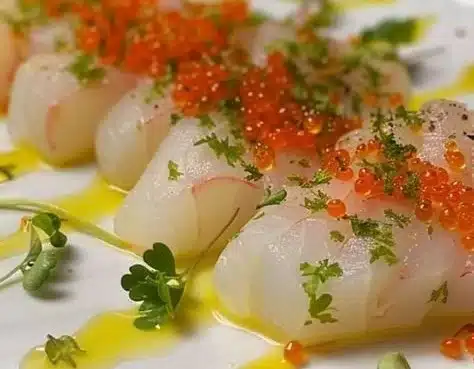 Finger Lime & Scallop Crudo 7 Finger lime and scallop crudo plated beautifully, showcasing fresh seafood.