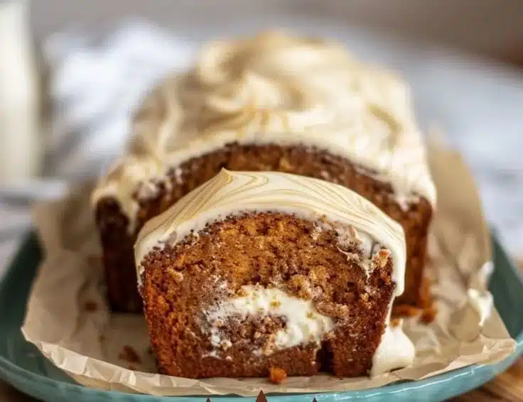 Ginger Molasses Cream Cheese Swirl Loaf garnished with spices and cream cheese