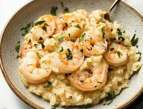 Quick lemon garlic shrimp risotto in a bowl with fresh parsley garnish.