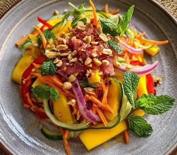 Zesty Thai Mango Salad with fresh ingredients and colorful presentation