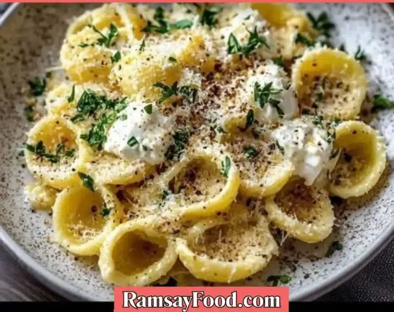 Delicious burrata pasta shells topped with herbs and sauce