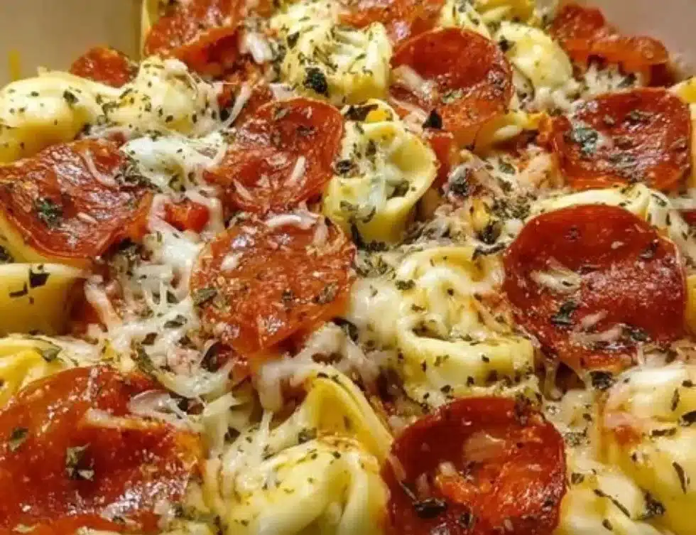 Cheese tortellini pepperoni pizza topped with herbs and cheese