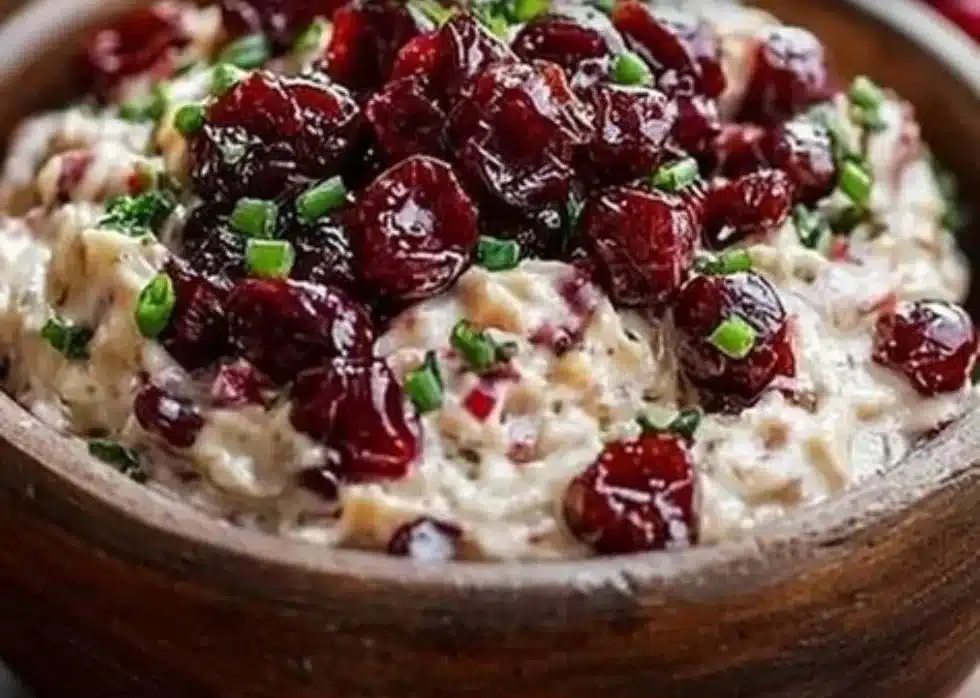 Cranberry Jalapeno Cream Cheese Dip served in a bowl with crackers