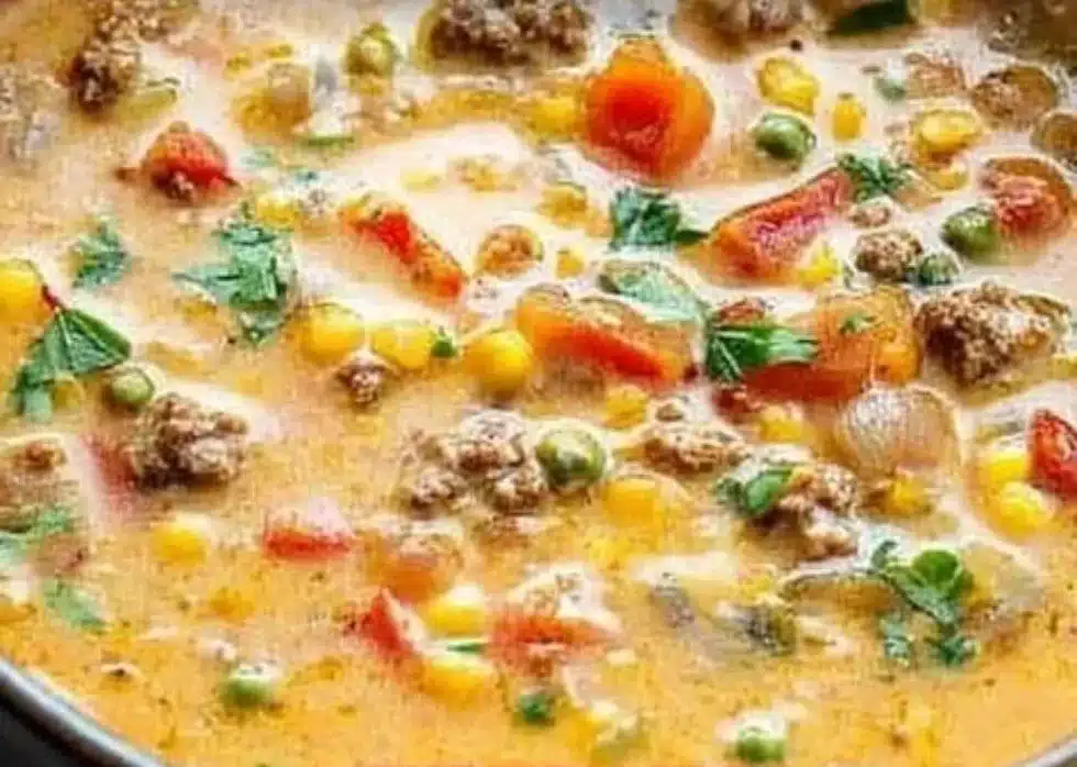 Bowl of easy creamy taco soup topped with cheese and cilantro.