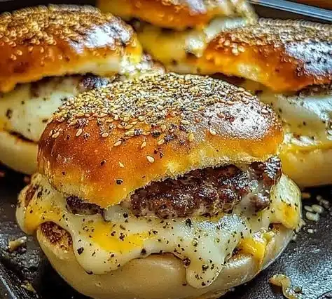 Gooey garlic parmesan cheeseburger bombs served on a plate.