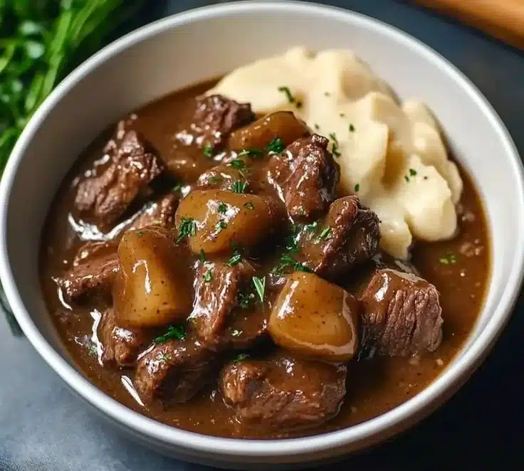 Hearty crock pot beef tips simmering in rich gravy, perfect for cold evenings.