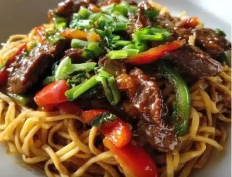 Delicious plate of Hoisin Beef Noodles garnished with fresh vegetables