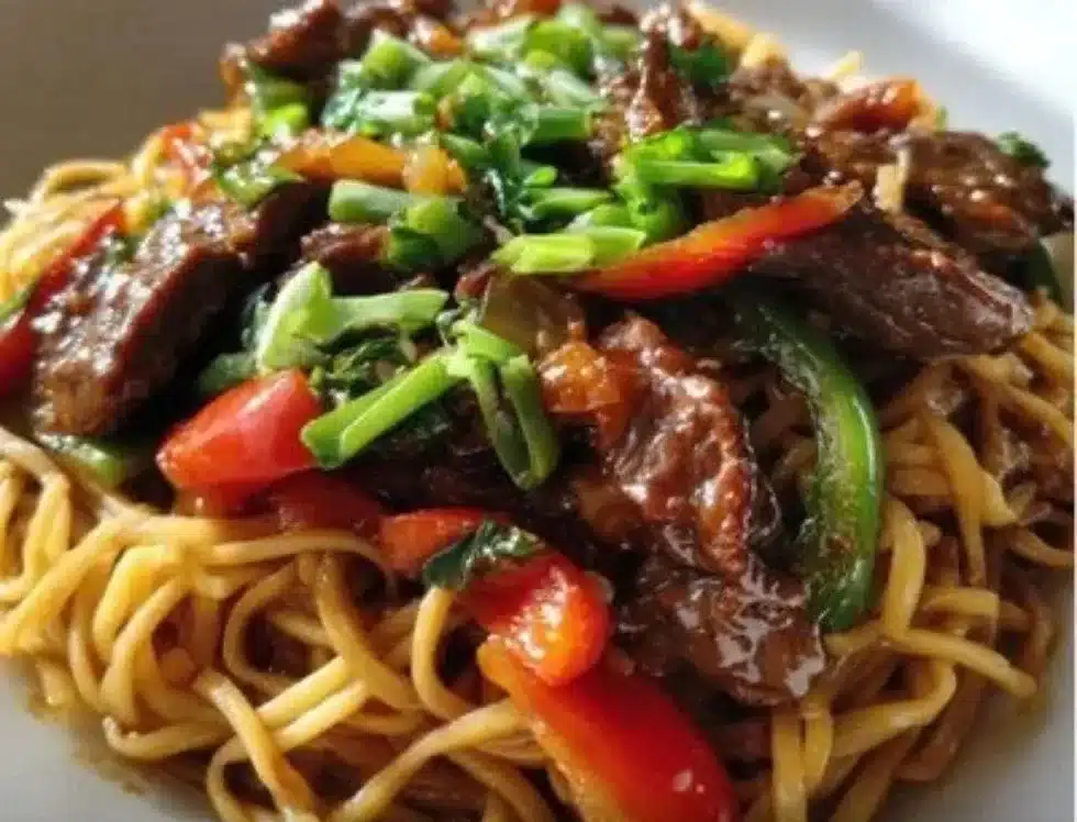 Delicious plate of Hoisin Beef Noodles garnished with fresh vegetables