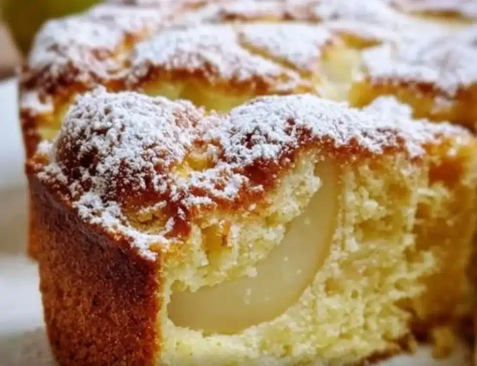 Slice of homemade Italian Pear Cake on a plate with fresh pear slices