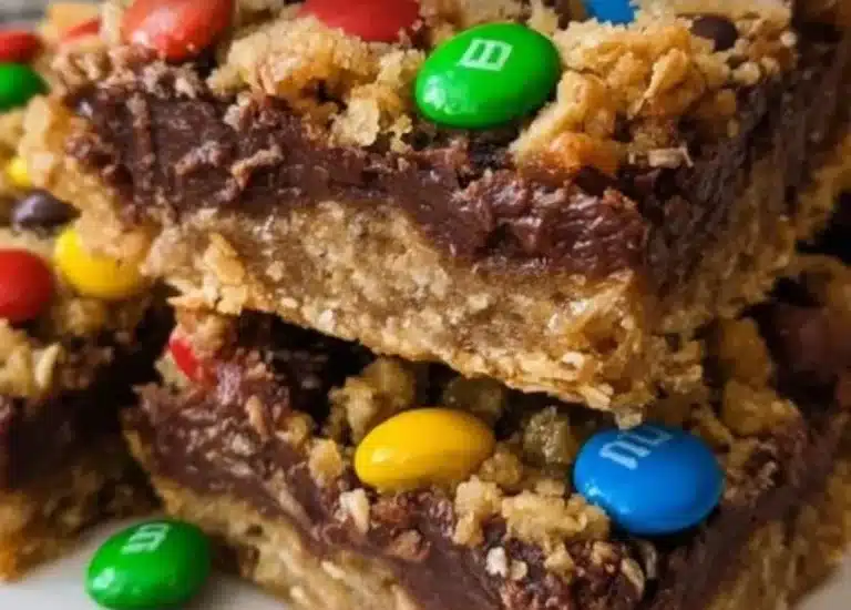 Delicious M&M chocolate fudge oatmeal bars on a wooden table