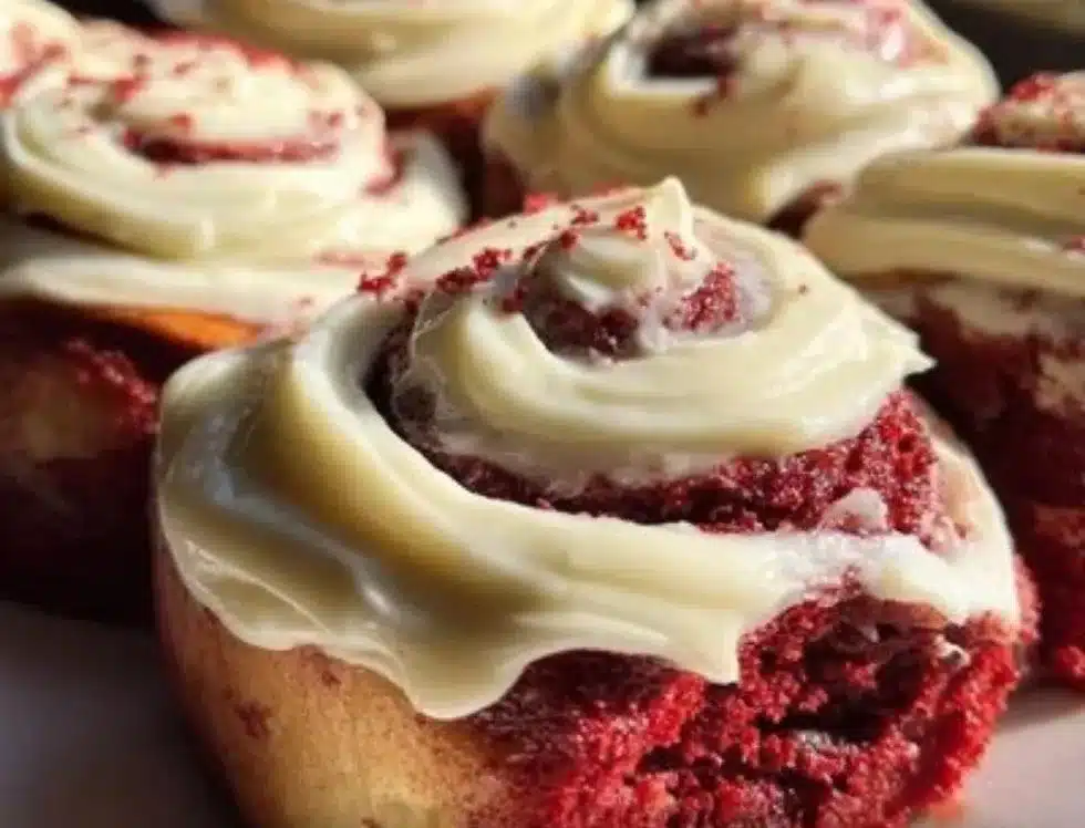 Delicious red velvet Valentine's cinnamon rolls topped with cream cheese icing.