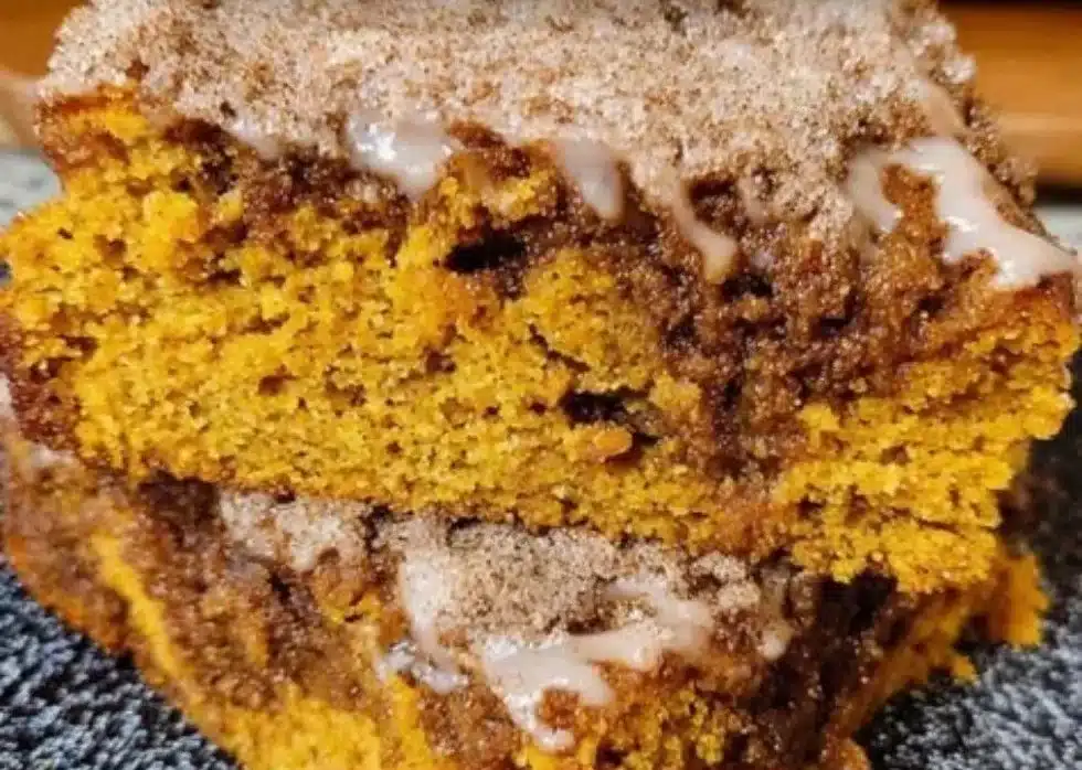 Delicious slice of sourdough pumpkin coffee cake topped with cream and spices