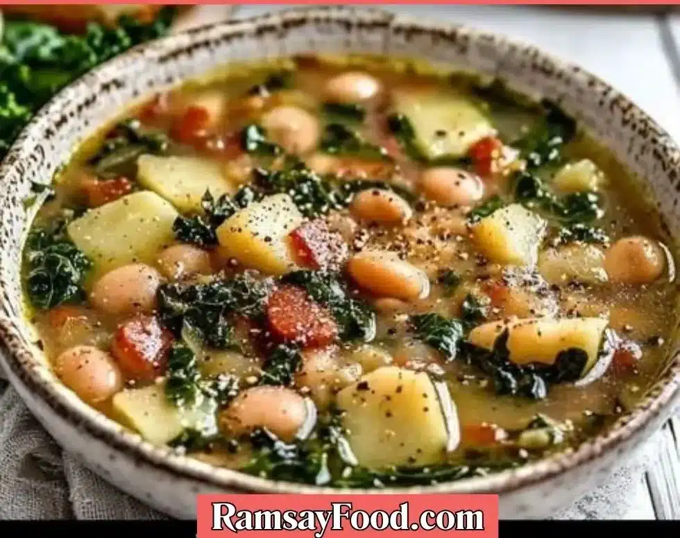 Bowl of Tuscan Kale Potato Bean Soup topped with fresh herbs.
